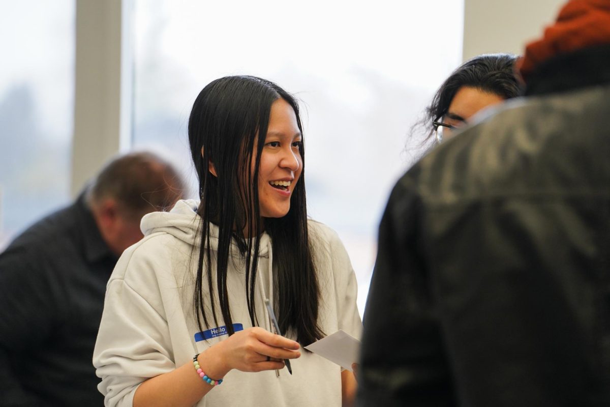Iowa State linguistics student TK Haong speaks with fellow attendees of the Speed Friending event at the Ames Public Library, Feb. 3, 2024. 