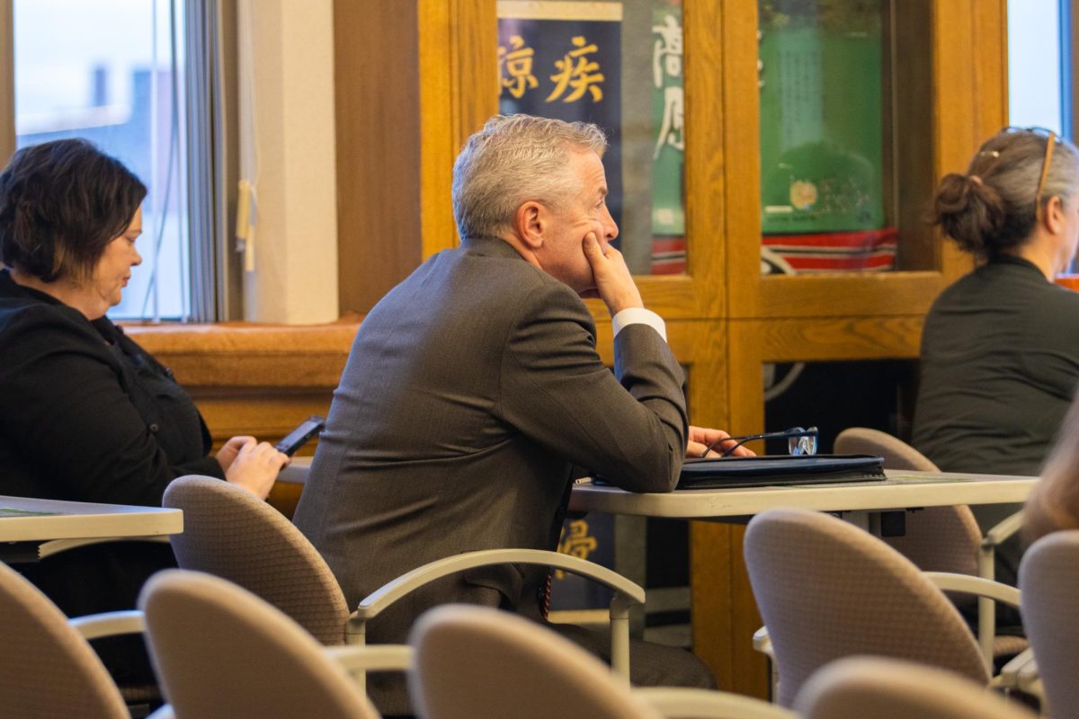 A community member listens during the Ames City Council meeting on Feb. 6, 2023 at Ames City Hall.