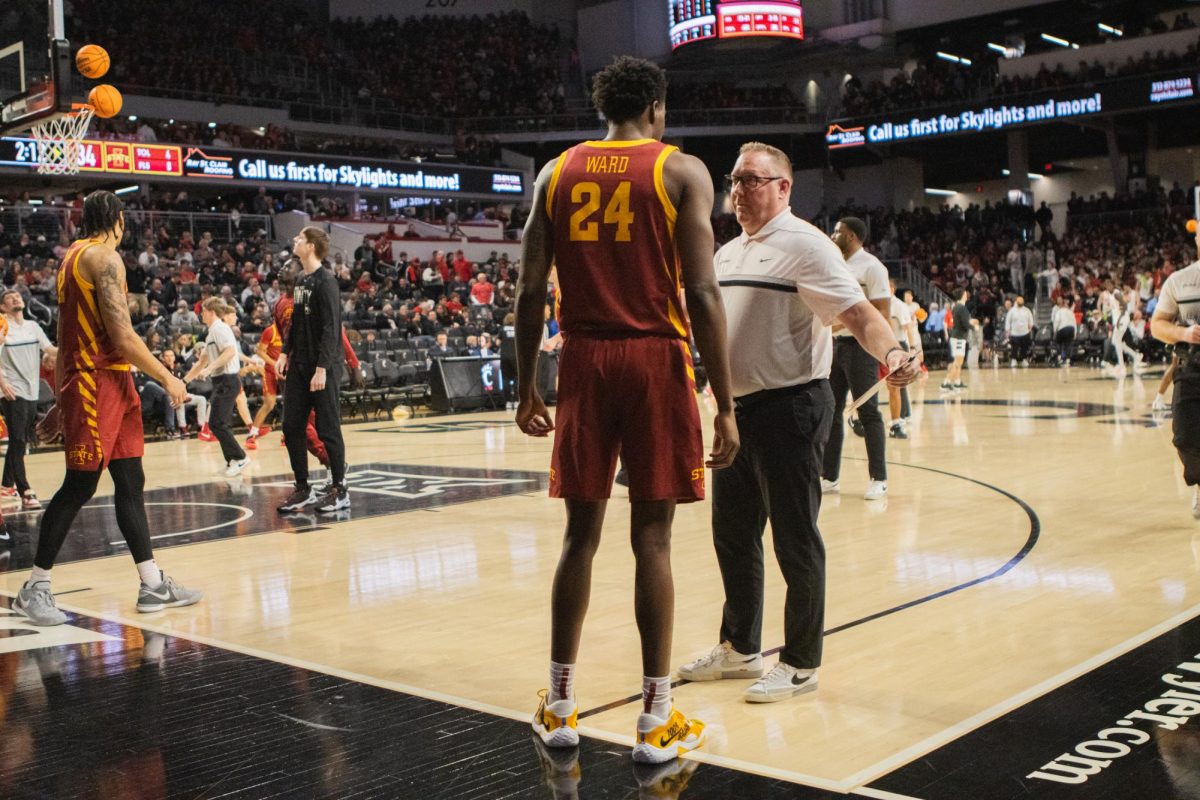 Hason Ward talks to Kyle Green during half time of the Iowa State vs Cincinnati basketball game at Fifth Third Arena in Cincinnati, Feb. 13, 2024.