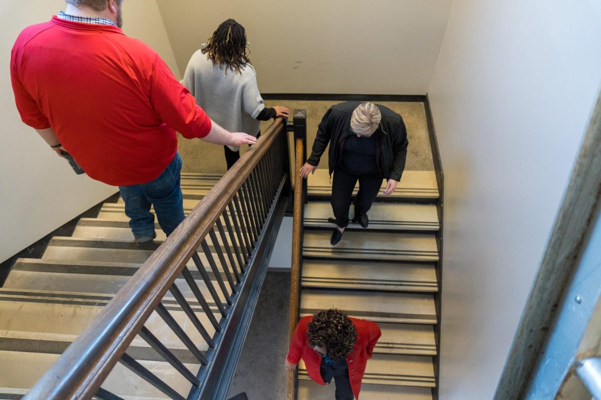 Iowa State University administration follow protestors down the stairs at the Armory on Feb. 1, 2024. 