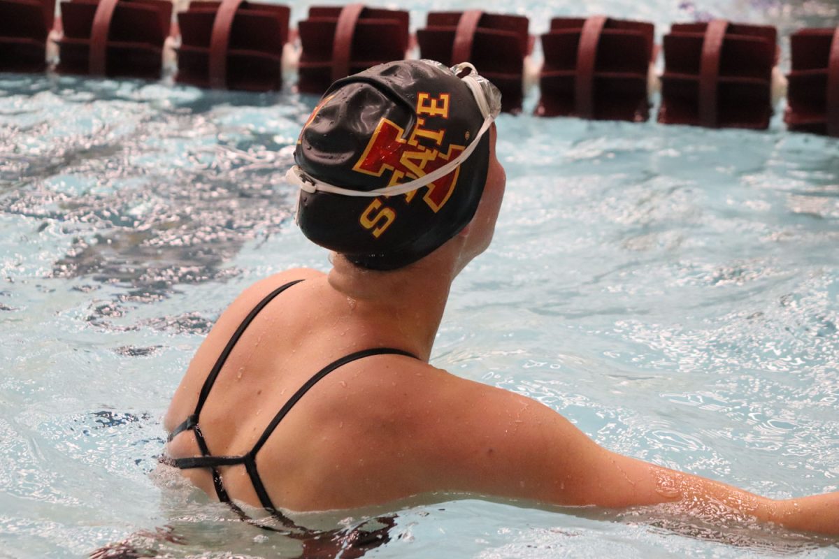 An Iowa State swimmer looks up at the scoreboard to check their time at the Iowa State vs. Kansas swim and diving meet at Beyer Hall on Feb. 9, 2024. 