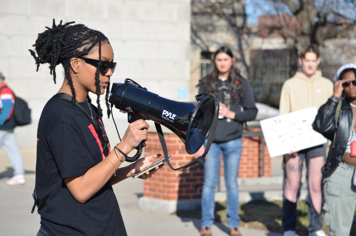Lyric Sellers reads a statement from her phone to fellow protesters at the beginning of a protest outside Parks Library on Thursday, Feb. 1, 2024. The protest was organized by Color of Love, a student organization at Iowa State.