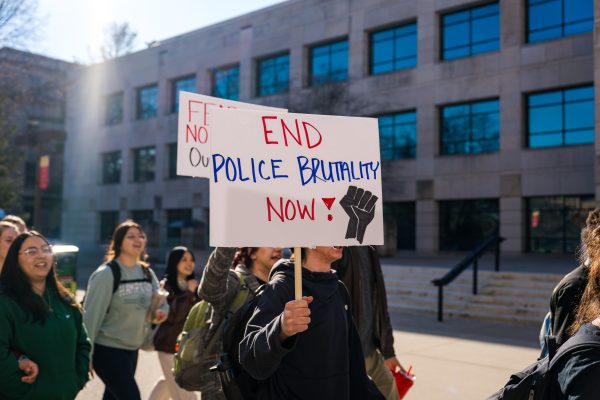 Un-named student holds sign up demanding the end of police brutality now during the ISUPD Officer Frankie Contreras protest organized by Color of Love on Feb. 1, 2024.