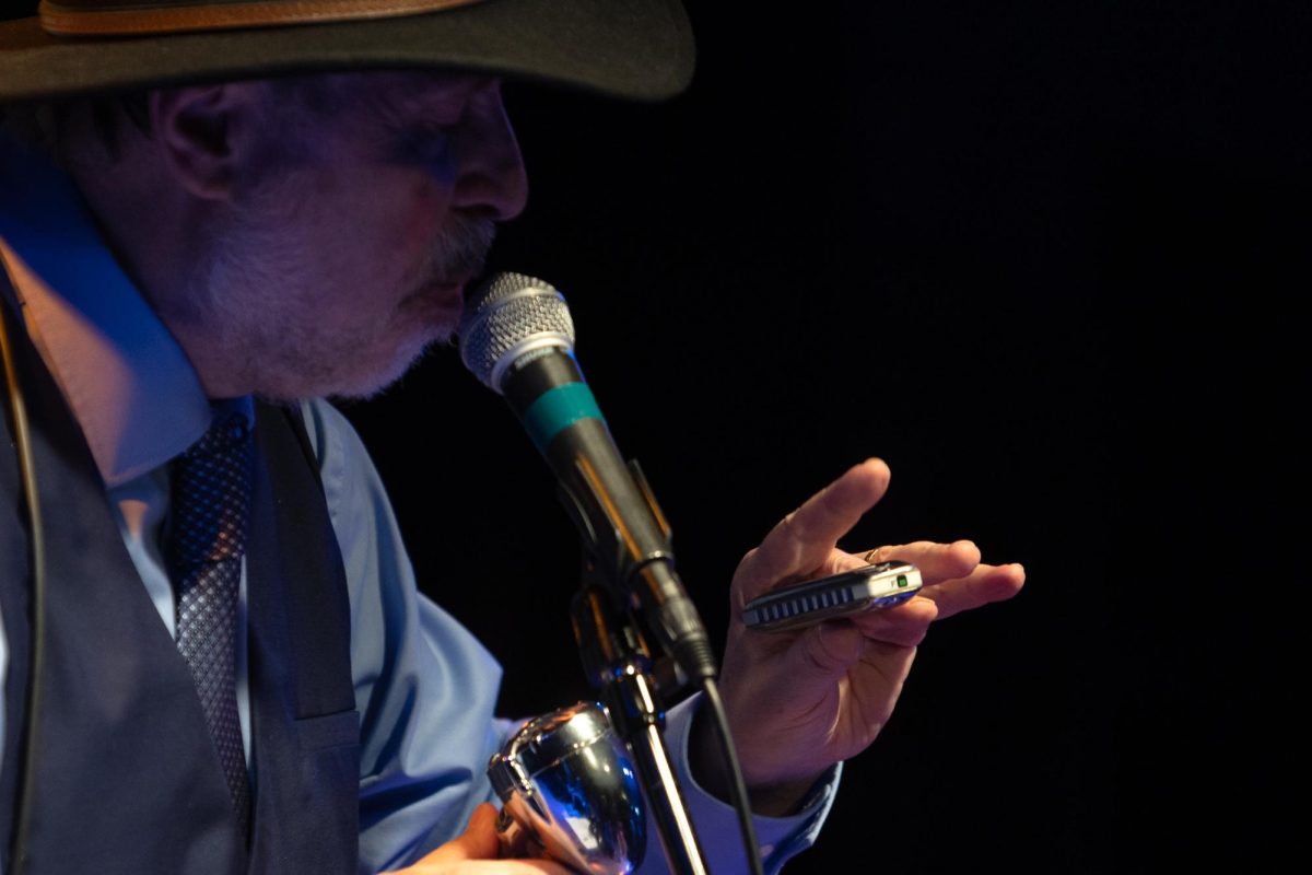 Pierre Lacocque sings with his harmonica at the Maintenance Shop on Feb. 14.