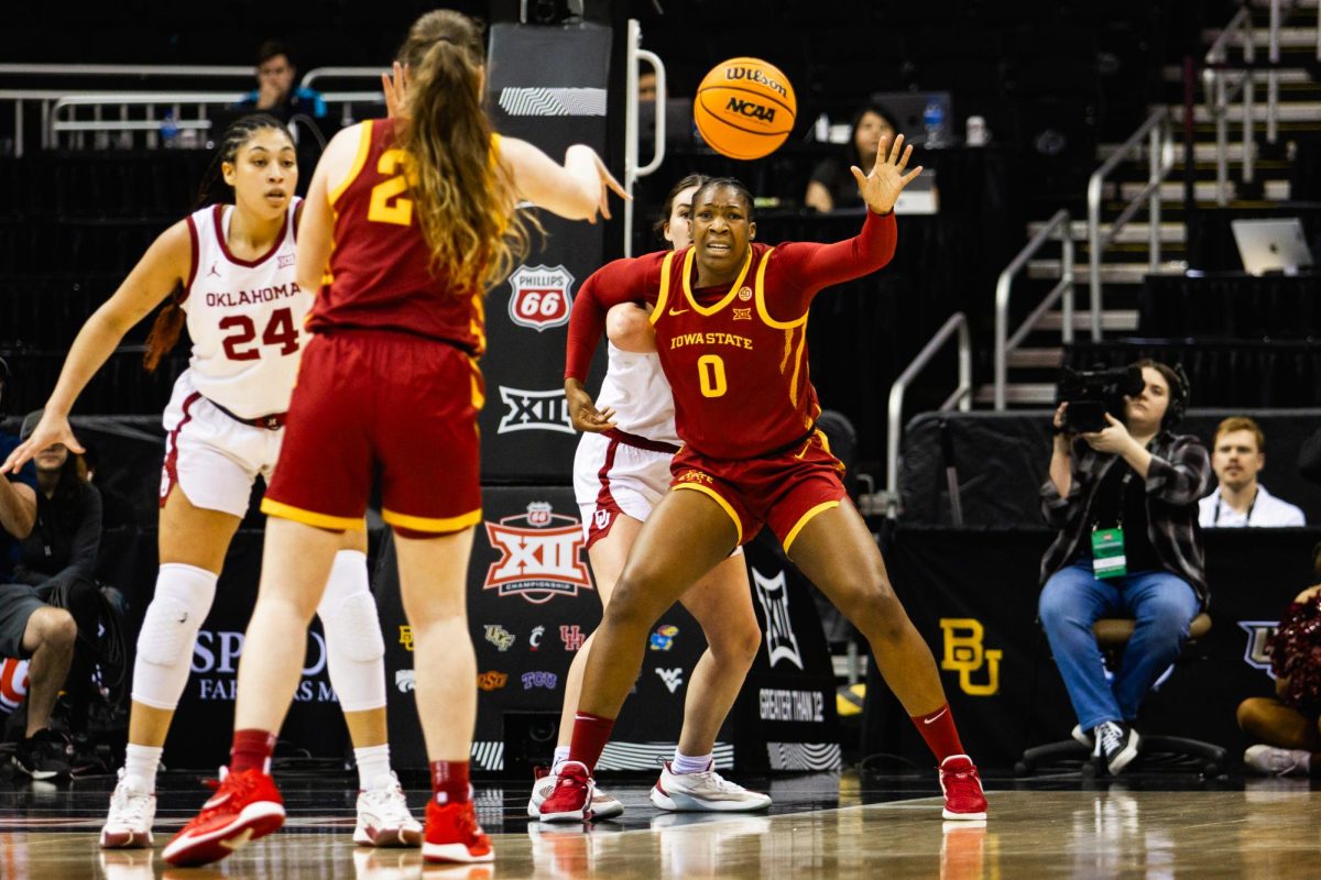 Addy Brown (24) passes the ball to Isnelle Natabou (0) as she posts up during the Iowa State vs. Oklahoma basketball game at T-Mobile Center, March 11, 2024.