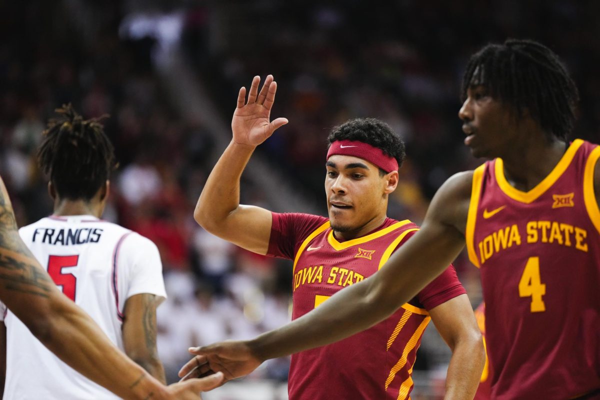 Tamin Lipsey goes to high five his teammates during the mens basketball Big 12 Championship game against Houston, T-Mobile Center, Kansas City, March 16, 2024.