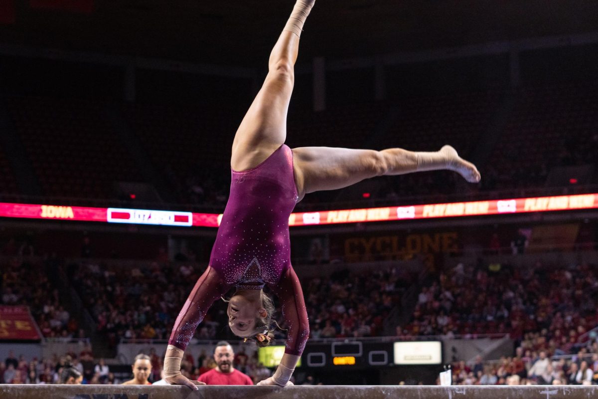 Rachel Wilke cartwheels in her beam routine as part of the Iowa Corn Cy-Hawk series gymnastics meet against the University of Iowa, Hilton Coliseum, March 8, 2024.