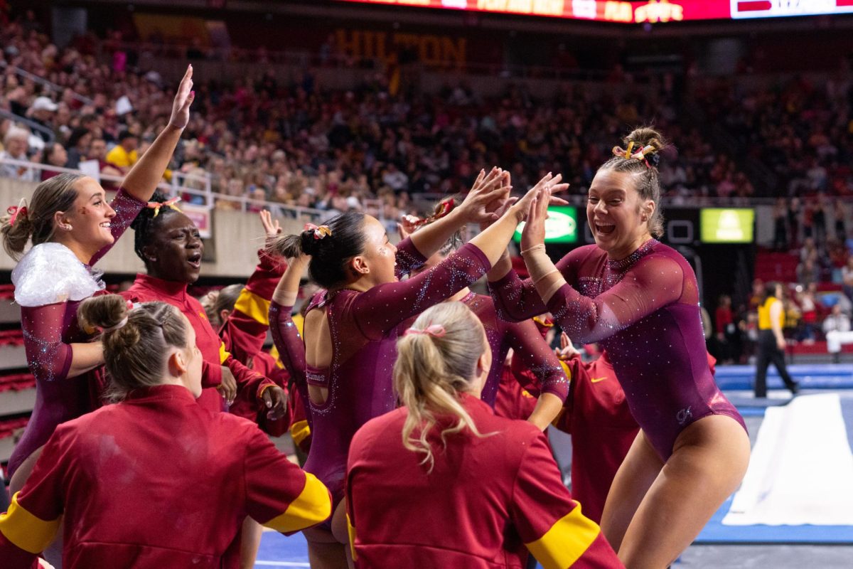 Rachel Wilke celebrates with the Cyclones after her beam routine as part of the Iowa Corn Cy-Hawk series gymnastics meet against the University of Iowa, Hilton Coliseum, March 8, 2024.