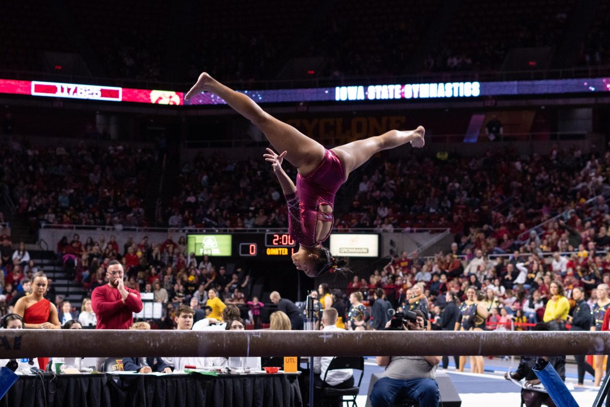Noelle Adams flips on the beam during her routine as part of the Iowa Corn Cy-Hawk series gymnastics meet against the University of Iowa, Hilton Coliseum, March 8, 2024.