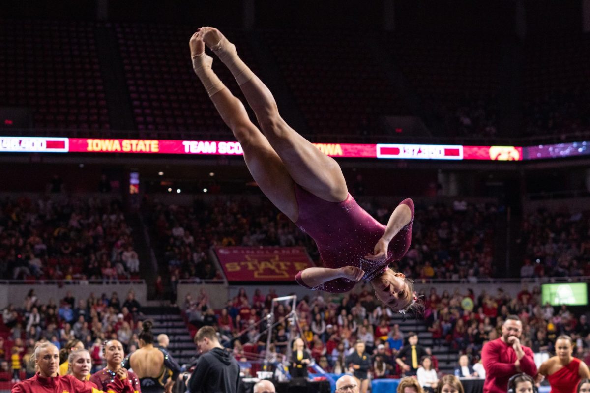 Josie Bergstrom dismounts from the beam during her routine as part of the Iowa Corn Cy-Hawk series gymnastics meet against the University of Iowa, Hilton Coliseum, March 8, 2024.