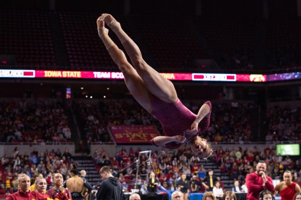 Josie Bergstrom dismounts from the beam during her routine as part of the Iowa Corn Cy-Hawk series gymnastics meet against the University of Iowa, Hilton Coliseum, March 8, 2024.