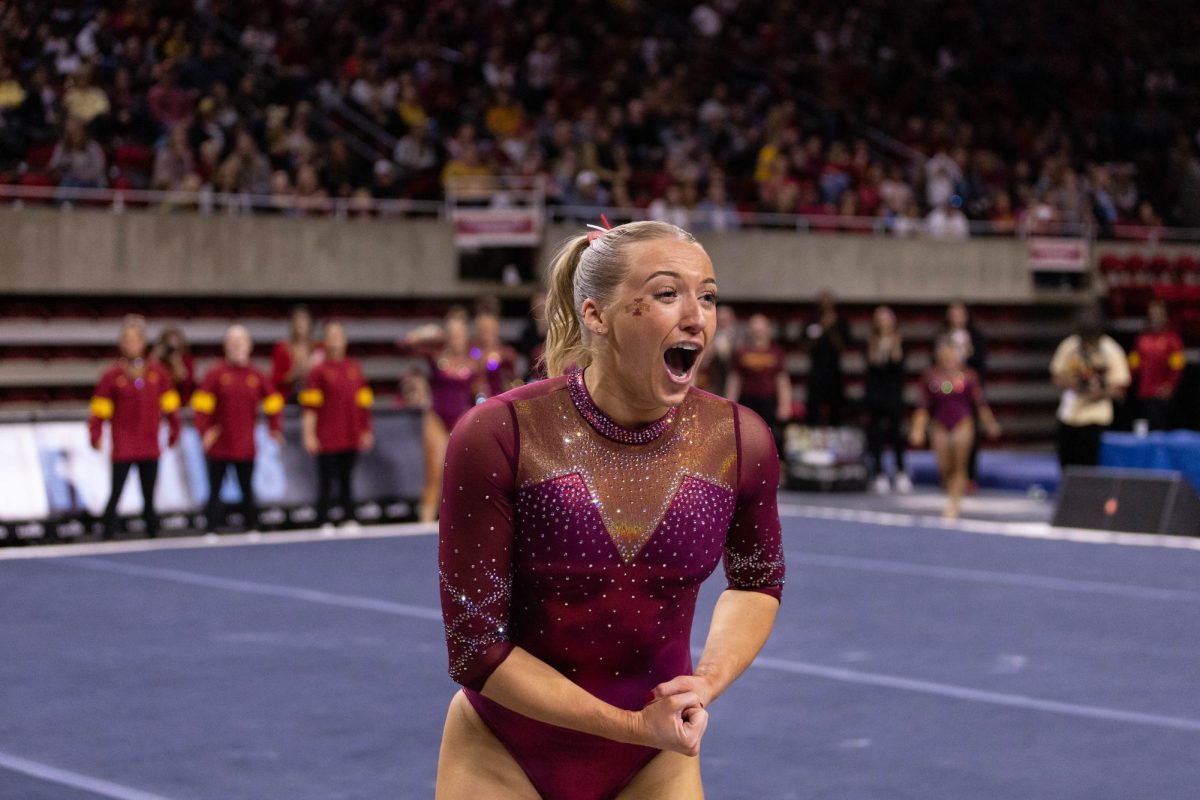 Laura Cooke celebrates after her floor routine as part of the Iowa Corn Cy-Hawk series gymnastics meet against the University of Iowa, Hilton Coliseum, March 8, 2024.