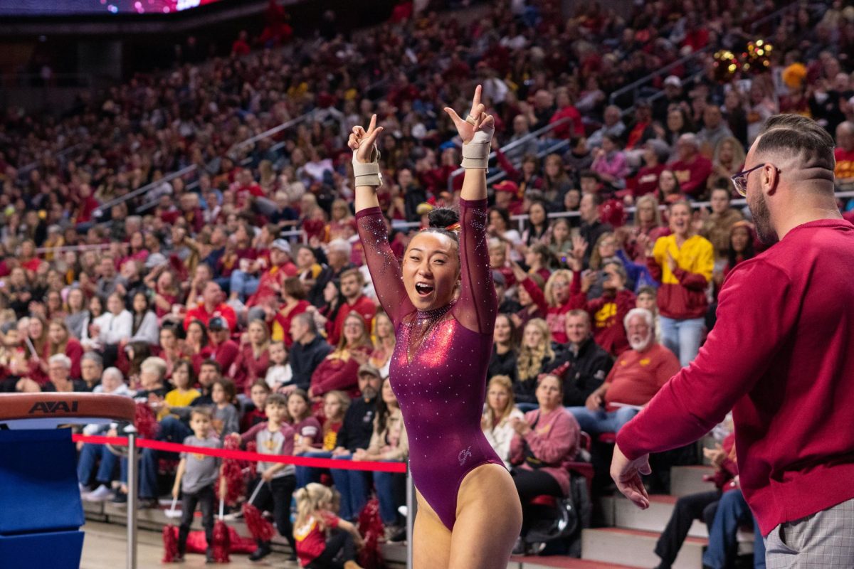 Emilie Hong celebrates after her vault routine as part of the Iowa Corn Cy-Hawk series gymnastics meet against the University of Iowa, Hilton Coliseum, March 8, 2024.