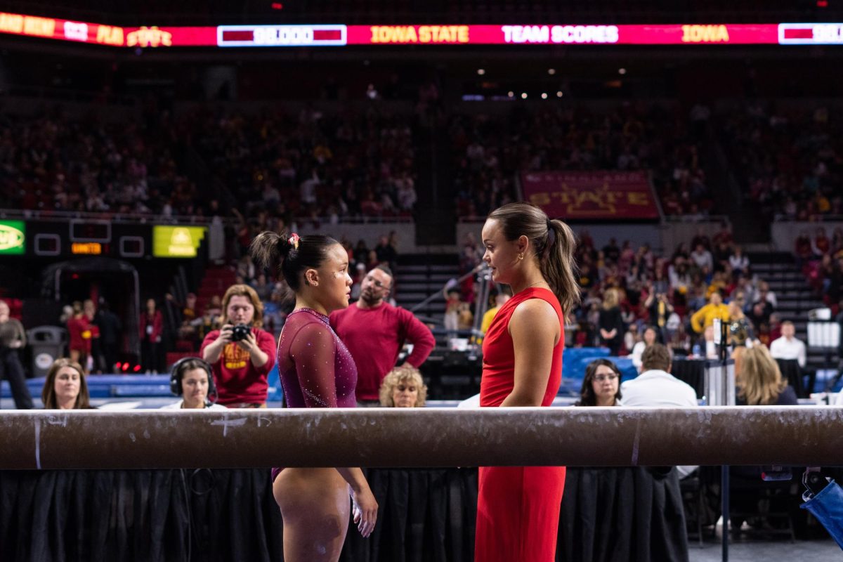 Hannah Loyim talks her coach Haylee Young before her beam routine as part of the Iowa Corn Cy-Hawk series gymnastics meet against the University of Iowa, Hilton Coliseum, March 8, 2024.