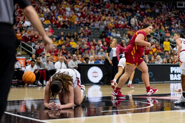 Audi Crooks walks away after blocking Oklahoma player Beatrice Culliton to the ground during the Big 12 Tournament in the T-Mobile Center on March 11, 2024.
