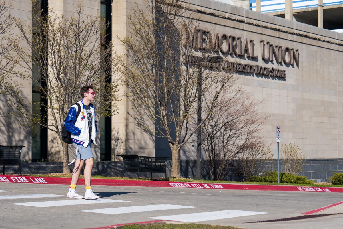 A student crosses the sidewalk out front of the Memorial Union on March 28, 2024.