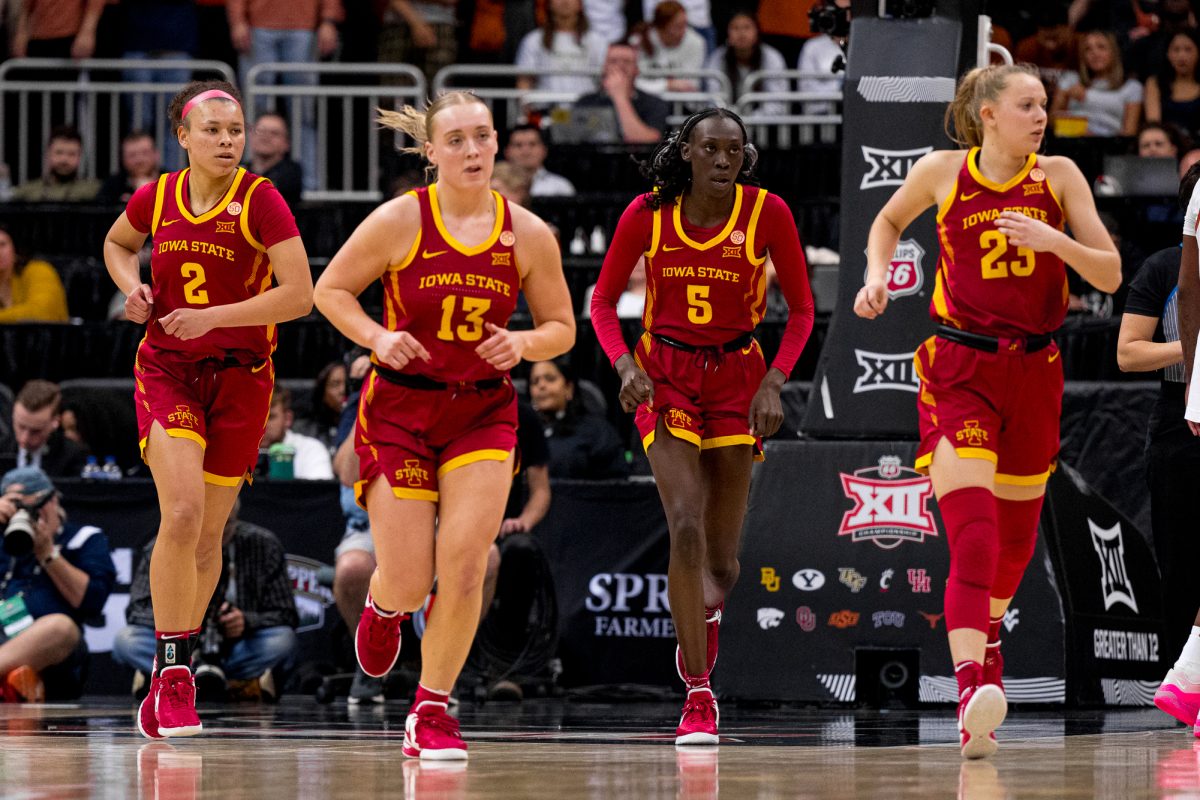 Iowa State players Arianna Jackson (2), Hannah Belanger (13), Nyamer Diew (5) and Kelsey Joens (23) run together as Texas calls a timeout during the Big 12 Tournament womens final on March 12, 2024, in the T-Mobile Center.