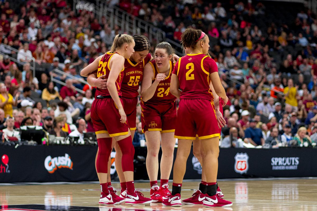 Iowa State players Kelsey Joens (23), Audi Crooks (55), Addy Brown (24), Emily Ryan (Hidden) and Arianna Jackson (2) huddle together discussing their next play on March 12, 2024, at the Big 12 Tournament Final.