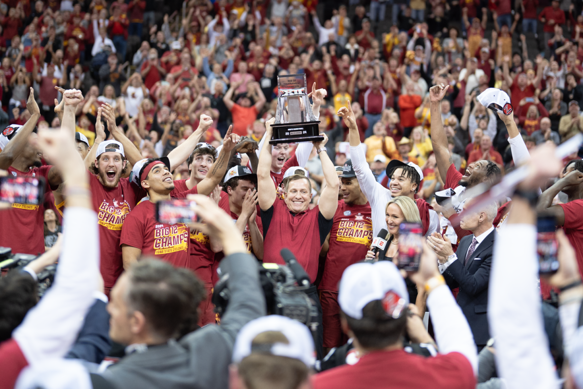 T.J. Otzelberger hoists the Big 12 Championship trophy after Iowa State defeats Houston in the Big 12 Championship 69-41 at the mens basketball Big 12 Championship game against Houston, T-Mobile Center, Kansas City, March 16, 2024.