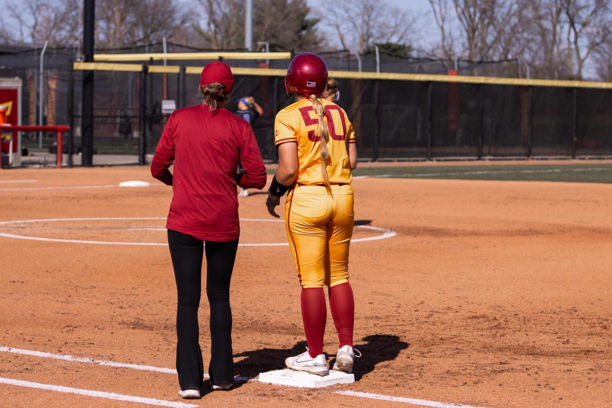 Ashley+Minor+and+her+coach+talk+at+first+base+during+the+Iowa+State+vs.+DePaul+softball+game+at+Cyclones+Sports+Complex%2C+April+9%2C+2024.