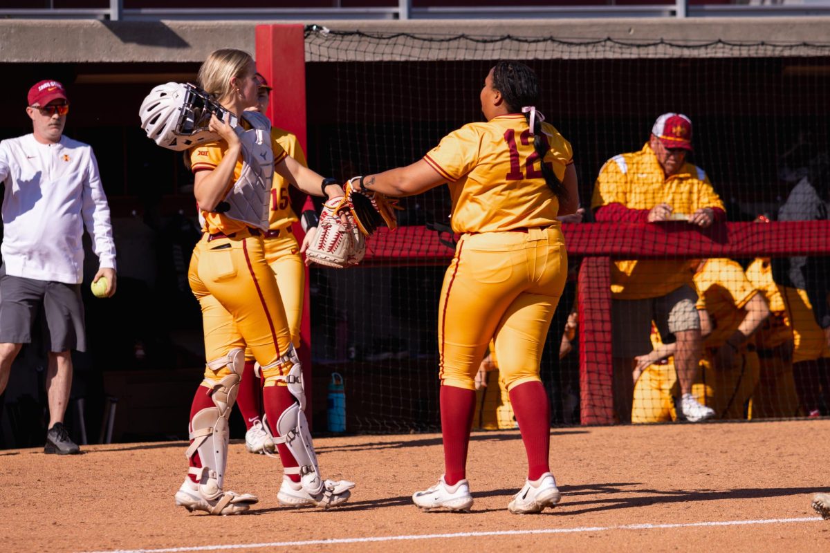 Maddie Knowles (L) and Karlie Charles (R) celebrate three outs after an inning during the Iowa State vs. DePaul softball game at Cyclones Sports Complex, April 9, 2024.