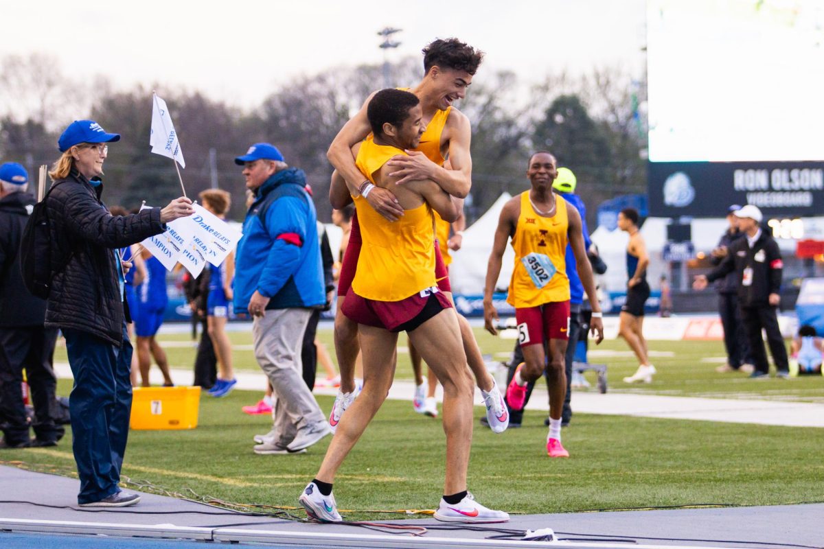 Devan Kipyego jumps into Peter Smiths arms after winning the 4x800m relay during the Drake Relays on April 26, 2024.
