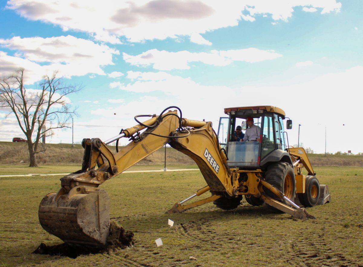 Iowa leaders and visitors watch as ground is broken for the new lab. Iowa Secretary of Agriculture Mike Naig in control of the excavator. April 4th, 2024 Veterinary Diagnostic Laboratory.
