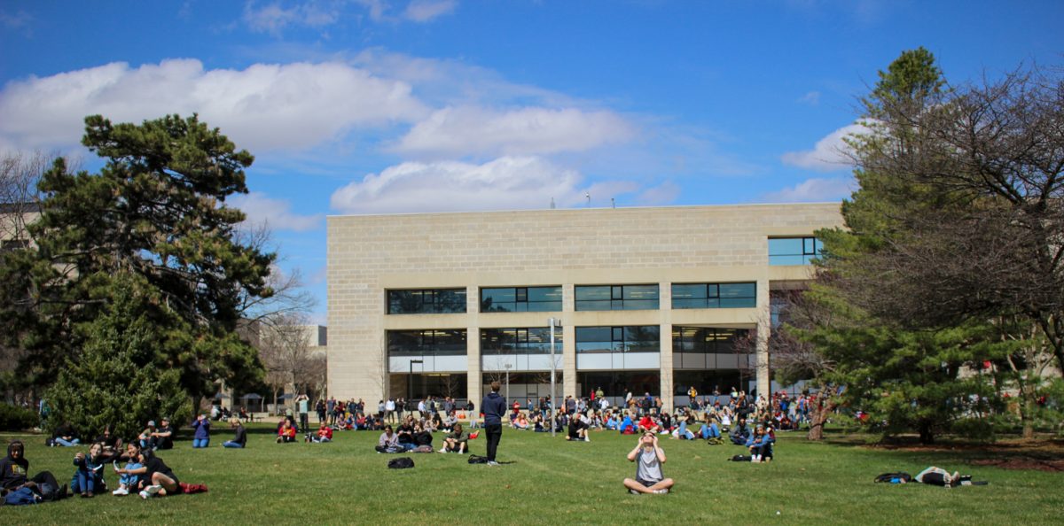 Iowa State Students crowd the front of parks library as the moon begins to cover the sun. Iowa State University Park Library Front Lawn, April 8th 2024.