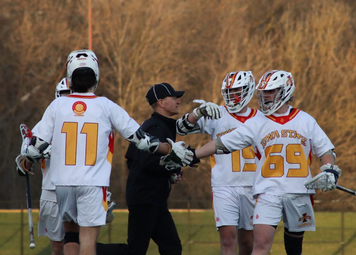 Colin Livesay and teammate Max Carlson high five after a goal is scored at the Iowa State vs. Illinois lacrosse game, April 5, 2024, at the Lied Recreation Center. 