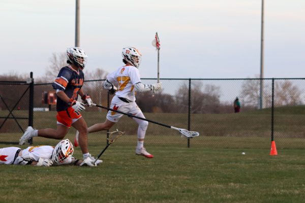 Tristan Telles runs ahead of Illinois opponent to gain possession of the ball at the Iowa State vs. Illinois lacrosse game, April 5, 2024, at the Lied Recreation Center. 