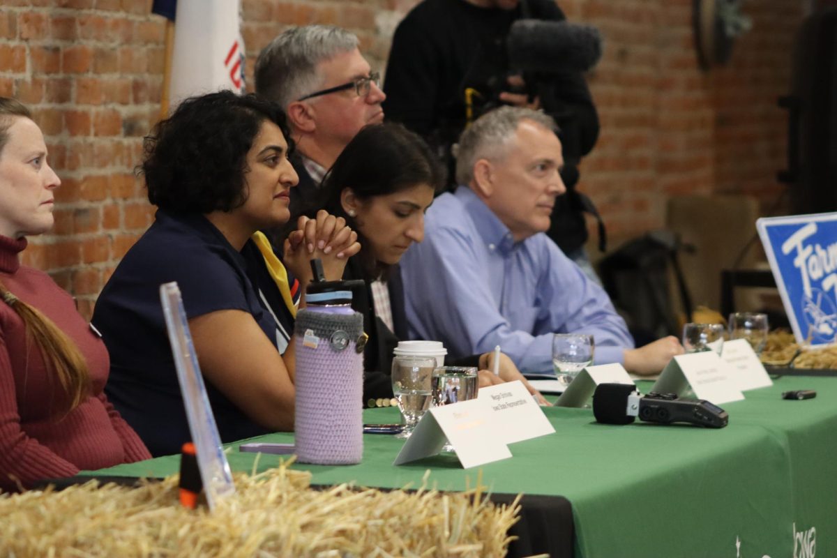 Lina Khan writing information down as an audience member speaks  at the FTC chair event in Nevada, IA on April 20, 2024.