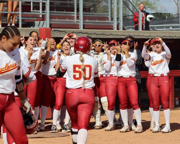 Ashley Minor and the Iowa State team celebrates after she hits a home run at the Iowa State vs. St. Thomas game at the Cyclones Sports Complex, April 23, 2024.