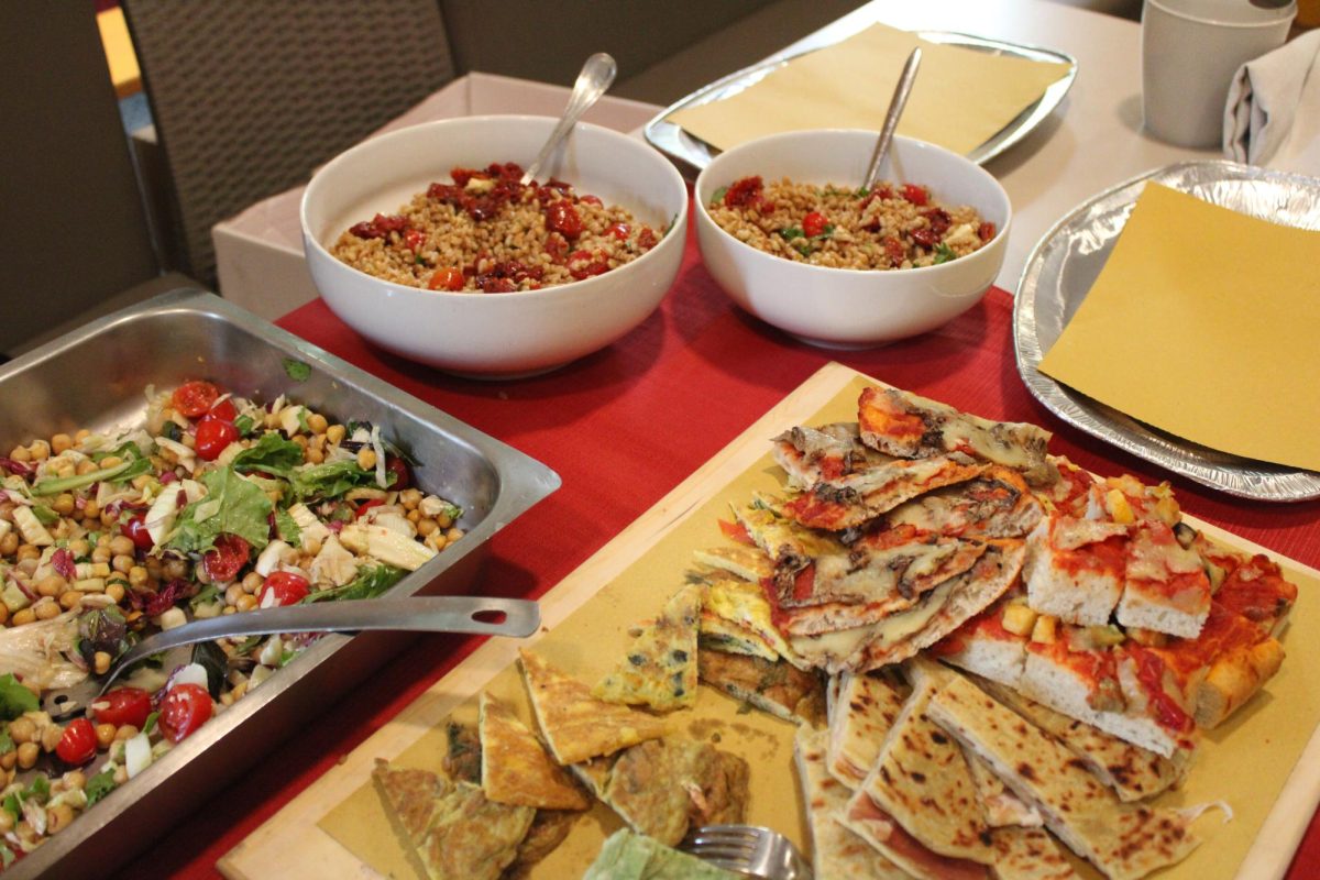 The food for the celebration made by Giovanni Garbugli, owner of Sugar Café and father of Agnese. Dried tomatoes, cheese and olives make up insalata di farro in the white bowls, along with chickpea salad, pizza, stuffed crescia sfogliata and omelettes.  