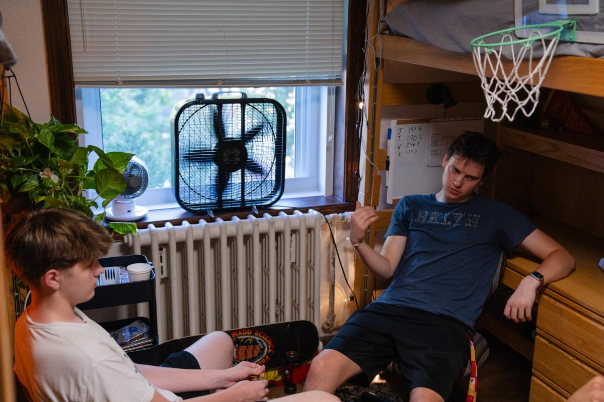 Trevor Deering and Justin Fallon, both freshman in mechanical engineering, sit next to the fans in their dorm window in Roberts Residence Hall, Aug. 26, 2024.