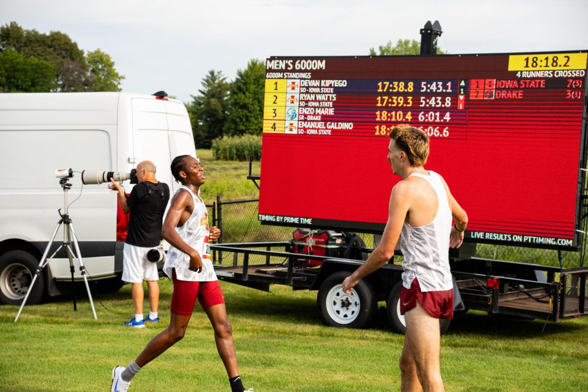 Ryan Watts congratulates Emanuel Galdino after finishing fourth at the Cyclone Preview Cross Country meet, Iowa State University Cross Country Course, Aug. 30, 2024.