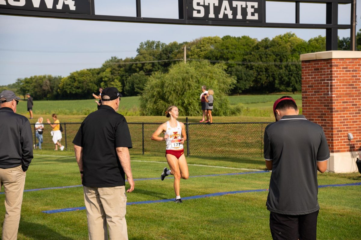 Bella Heikes glances at the scoreboard after finishing second at the Cyclone Preview Cross Country meet, Iowa State University Cross Country Course, Aug. 30, 2024.