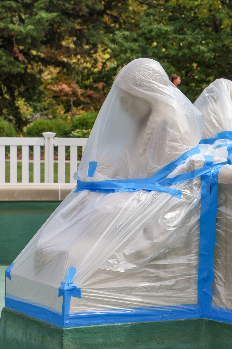 Fountain of the Four Seasons Sculptures covered in plastic wrap during construction, Aug. 27, 2024, in Ames, Iowa.