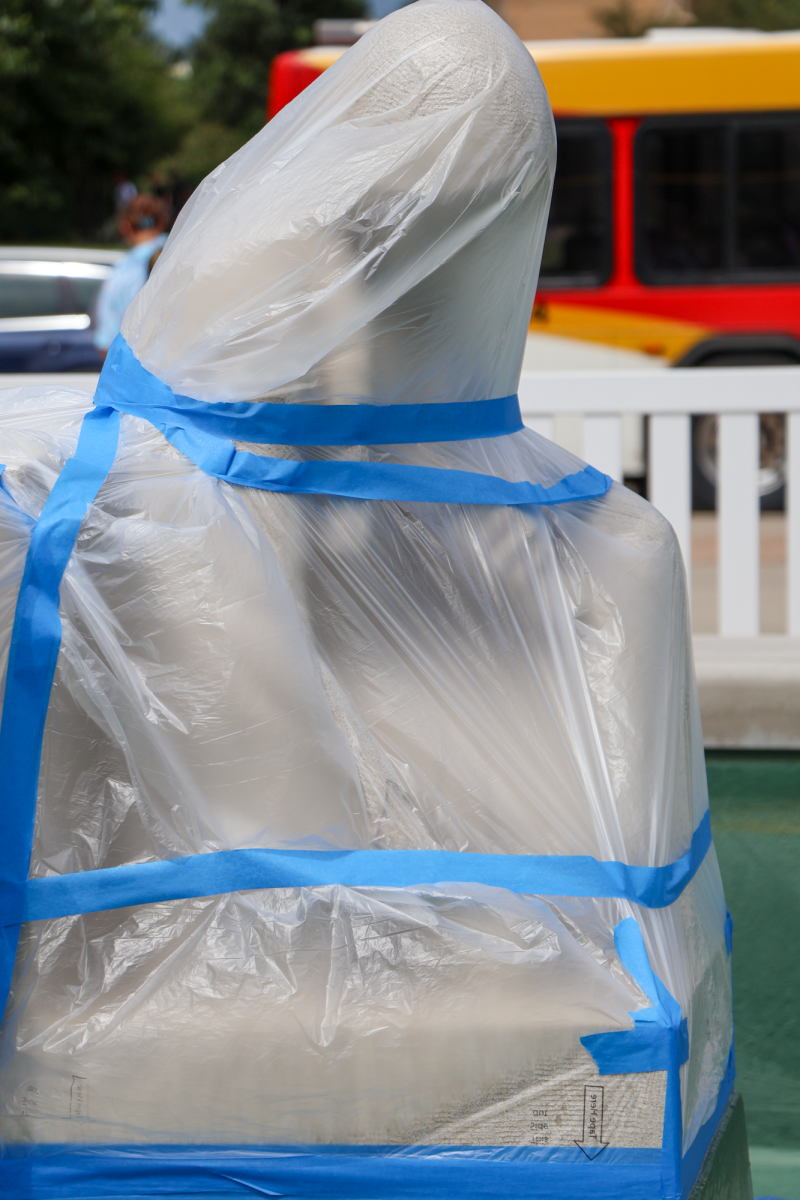 Fountain of the Four Seasons Sculptures covered in plastic wrap during construction, Aug. 27, 2024, in Ames, Iowa.