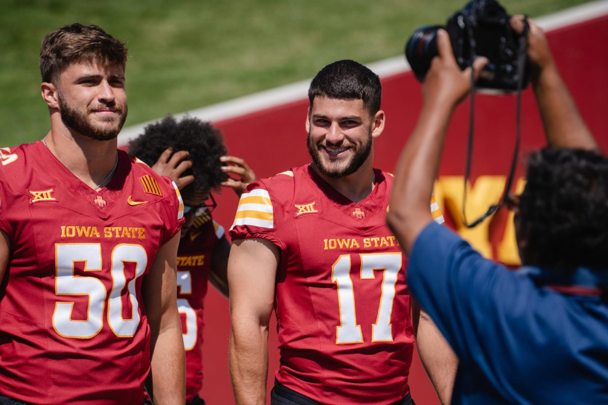Iowa State defensive back Beau Freyler (17) and linebacker Caleb Bacon (50) stand in front of a photographer during the Iowa State football media day on Aug. 2, 2024. 