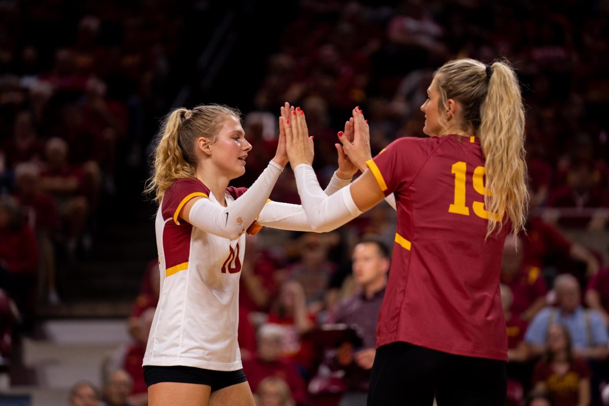 Rachel Van Gorp high-fiving Faith DeRonde after subbing into the Iowa State vs. Iowa match, Hilton Coliseum, Sept. 11, 2024.