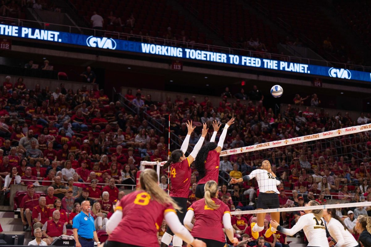 Iowa State attempts a block during the Iowa Corn Cy-Hawk series volleyball meet against the University of Iowa, Hilton Coliseum, Sept. 11, 2024.