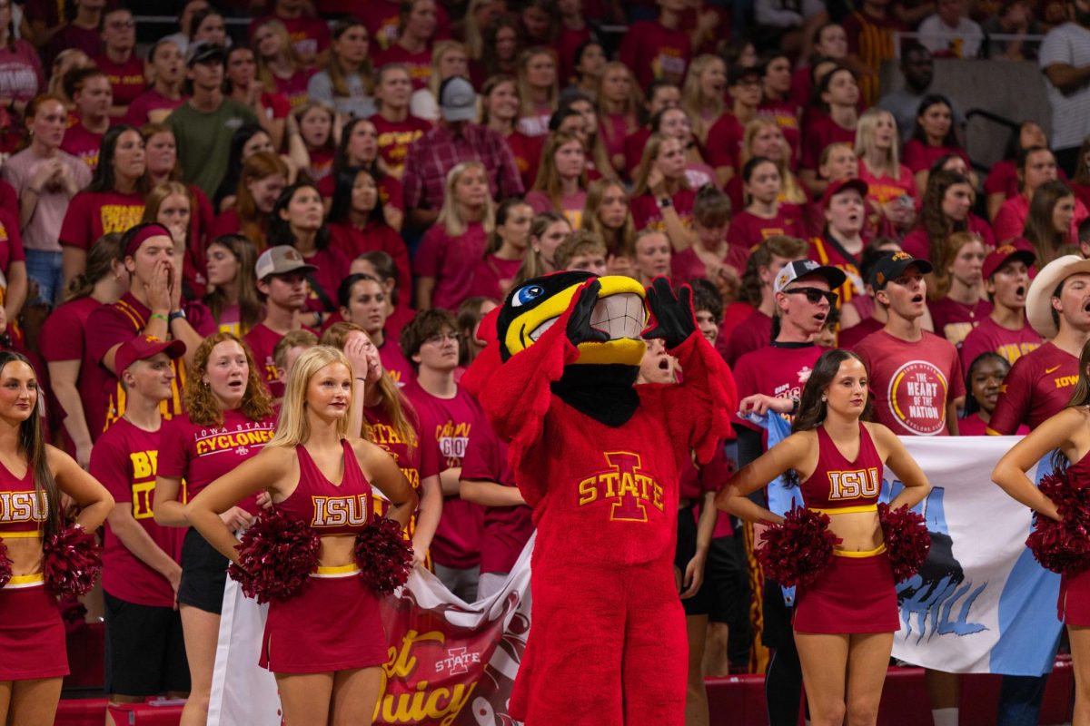 Cy Watches on and cheers with students during the Iowa Corn Cy-Hawk series volleyball meet against the University of Iowa, Hilton Coliseum, Sept. 11, 2024.