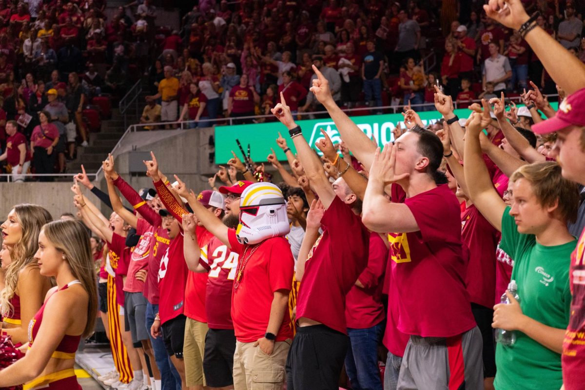 Iowa State student section cheers and raise a hand during the final match point at the Iowa Corn Cy-Hawk series volleyball meet against the University of Iowa, Hilton Coliseum, Sept. 11, 2024.