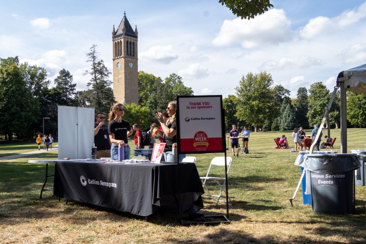 Taren Reker (Left) and Rebecca Kuzmich (Right) of Collins Aerospace working a welcome booth for the kickoff lunch of Business Week in central campus, Sept. 16, 2024, Ames, Iowa.