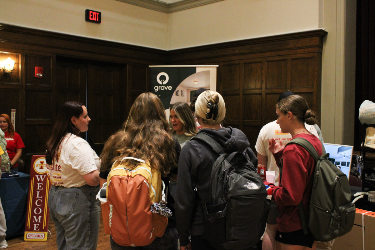 A groups of students talking to a Grove Apartment complex representative during the Housing Fair in Durham Great Hall, Sept. 26, 2024.