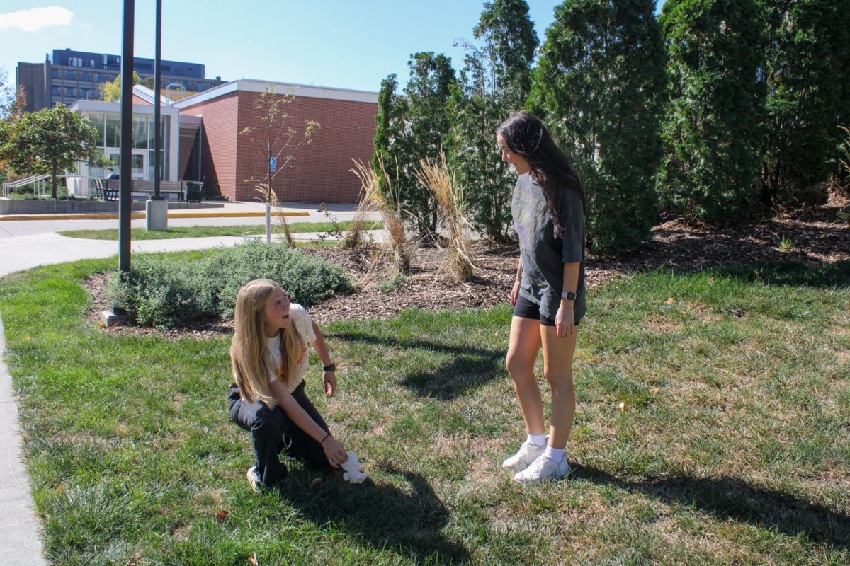 Mackenzy Ruff and Gabby Mowbray picking up trash on campus by Bessey Hall. Sept. 30, 2024.