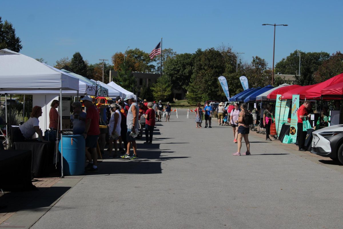 People gather and walk through Ames EcoFair, eager to learn about the sustainable ways of life outside Ames City Hall, Sept. 28, 2024.