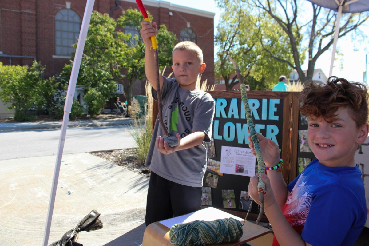 Enjoying Prairie Flowers Children's Center activities at Ames EcoFair, Mason Casey (Left) and Patrick Casey (Right) show their eco-friendly crafts outside the Ames City Hall, Sept. 28, 2024.