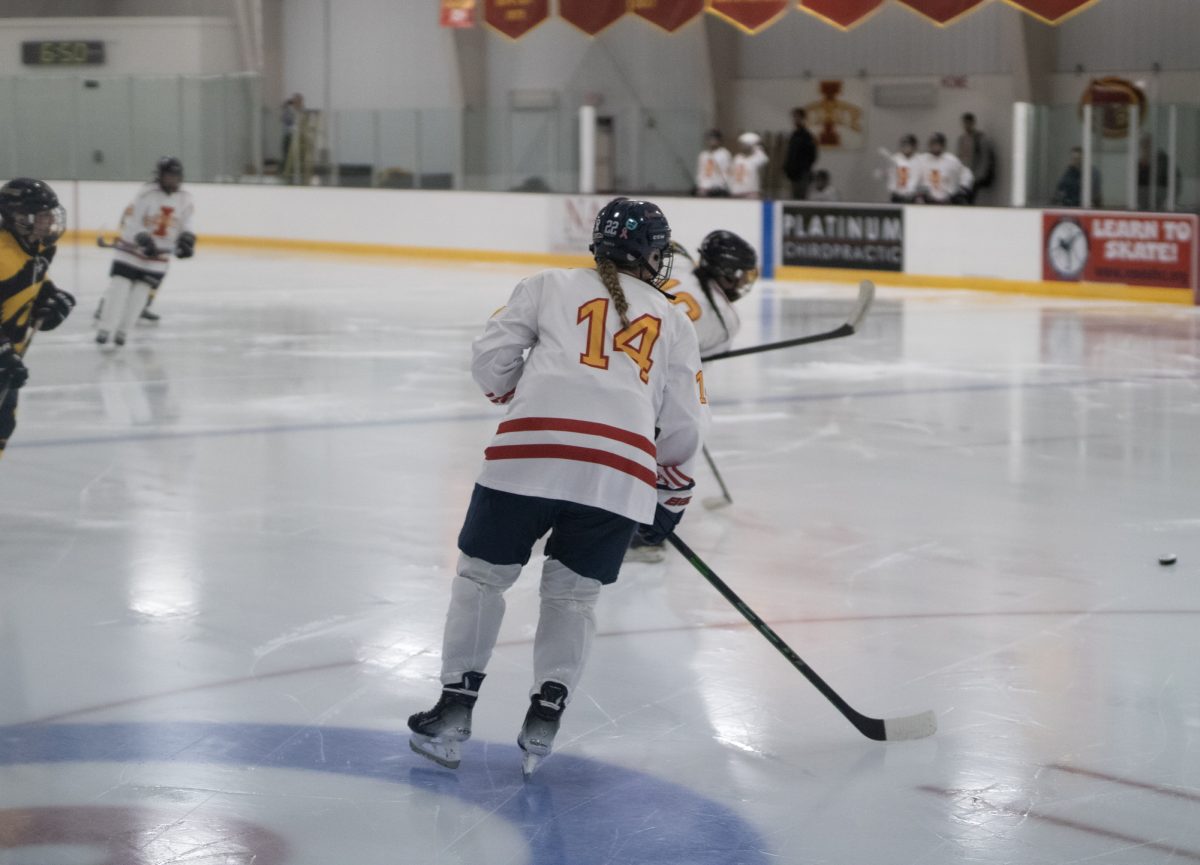 Iowa State's women's hokey club player number 14 playing defense versus the University of Iowa women's hockey club at the ISU Ice Arena, Sept. 27, 2024.