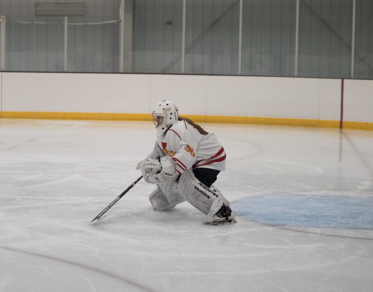 Iowa State's women hockey club player number 30 getting in a defense pose ready to block the puck versus the University of Iowa women's hockey club at the ISU Ice Arena, Sept. 27, 2024.